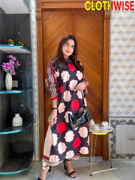 Woman in a patterned dress standing in a room with decor elements.