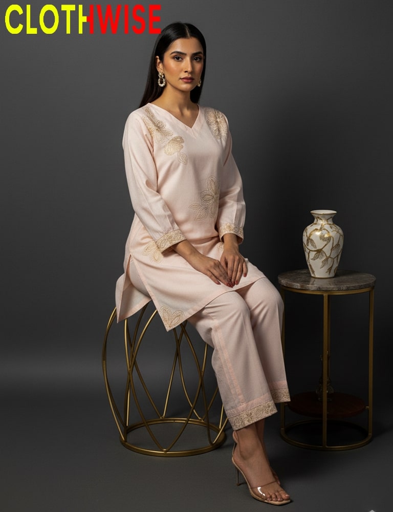 Woman in a light pink outfit sitting on a stool with a vase in the background, branded 'CLOTHWISE'.