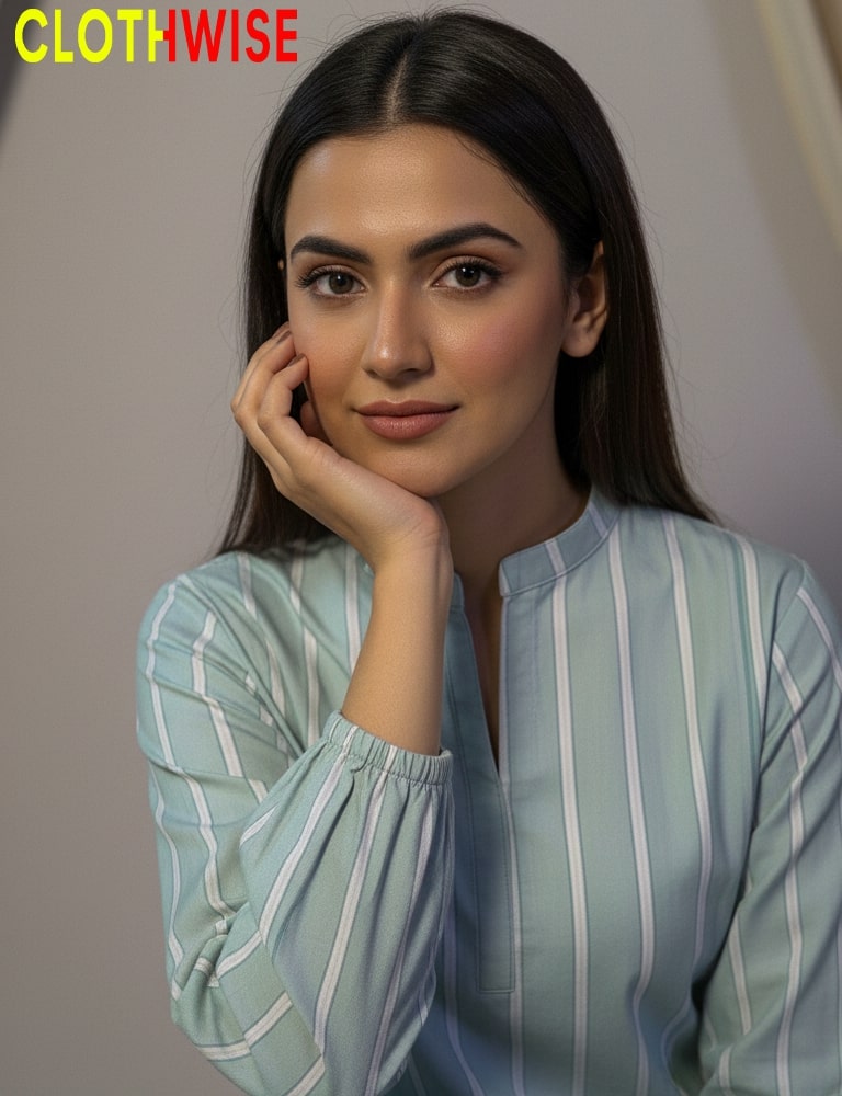 Woman wearing a light blue and white striped shirt with 'CLOTHWISE' branding.