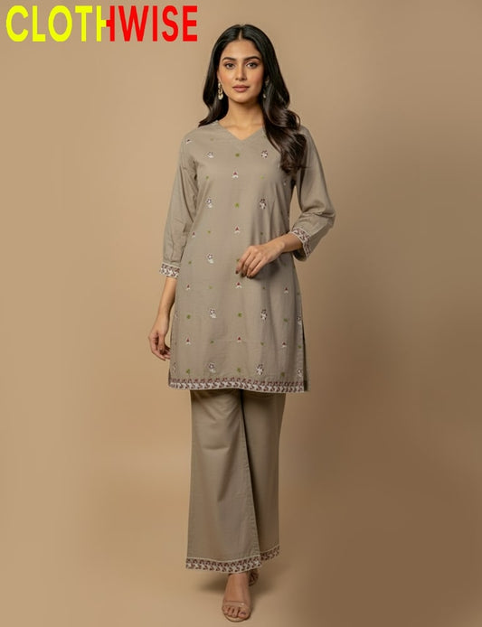 Woman wearing a gray embroidered outfit with 'CLOTHWISE' branding on a beige background