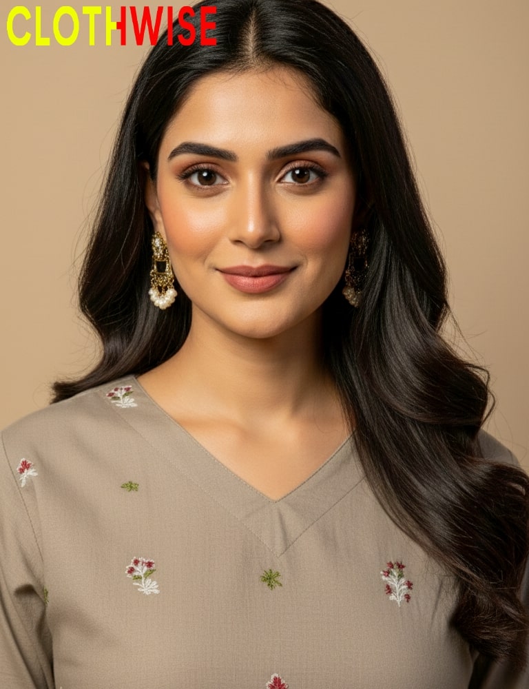 Woman wearing a beige embroidered top with 'CLOTHWISE' branding.