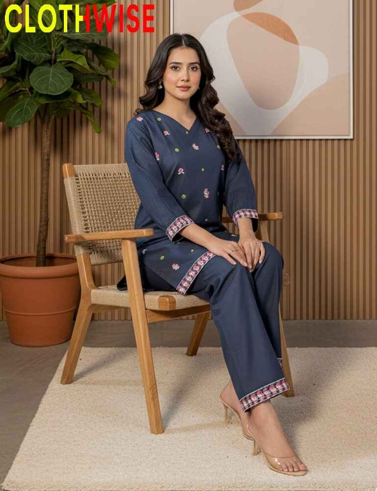 Woman in a navy blue outfit sitting on a wooden chair with 'CLOTHWISE' branding.