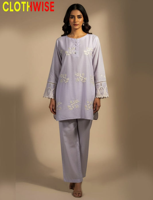 Woman wearing a white embroidered outfit with 'CLOTHWISE' branding.