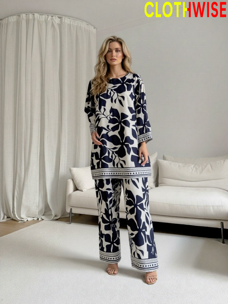Woman wearing a blue and white patterned outfit in a modern living room setting with 'ClothWise' branding.