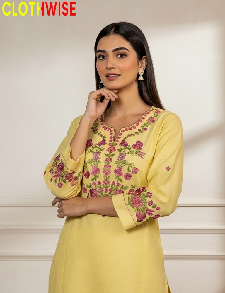 Woman wearing a yellow embroidered dress with a neutral background, branded 'CLOTHWISE'.
