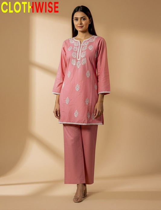 Woman wearing a pink embroidered outfit with 'CLOTHWISE' branding on a beige background