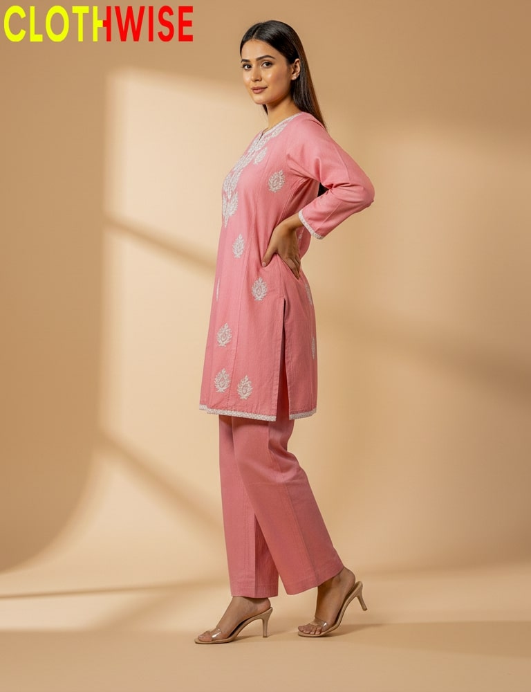 Woman wearing a pink outfit with floral patterns on a beige background, branded 'CLOTHWISE'.