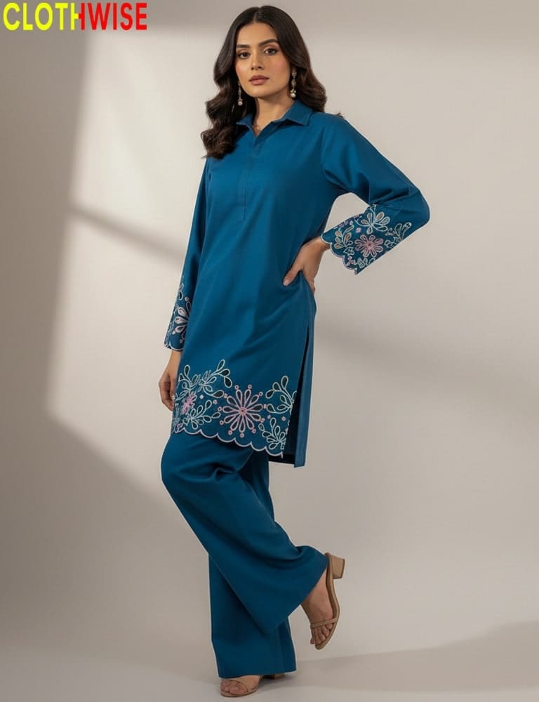 Woman wearing a blue embroidered outfit with 'CLOTHWISE' branding.