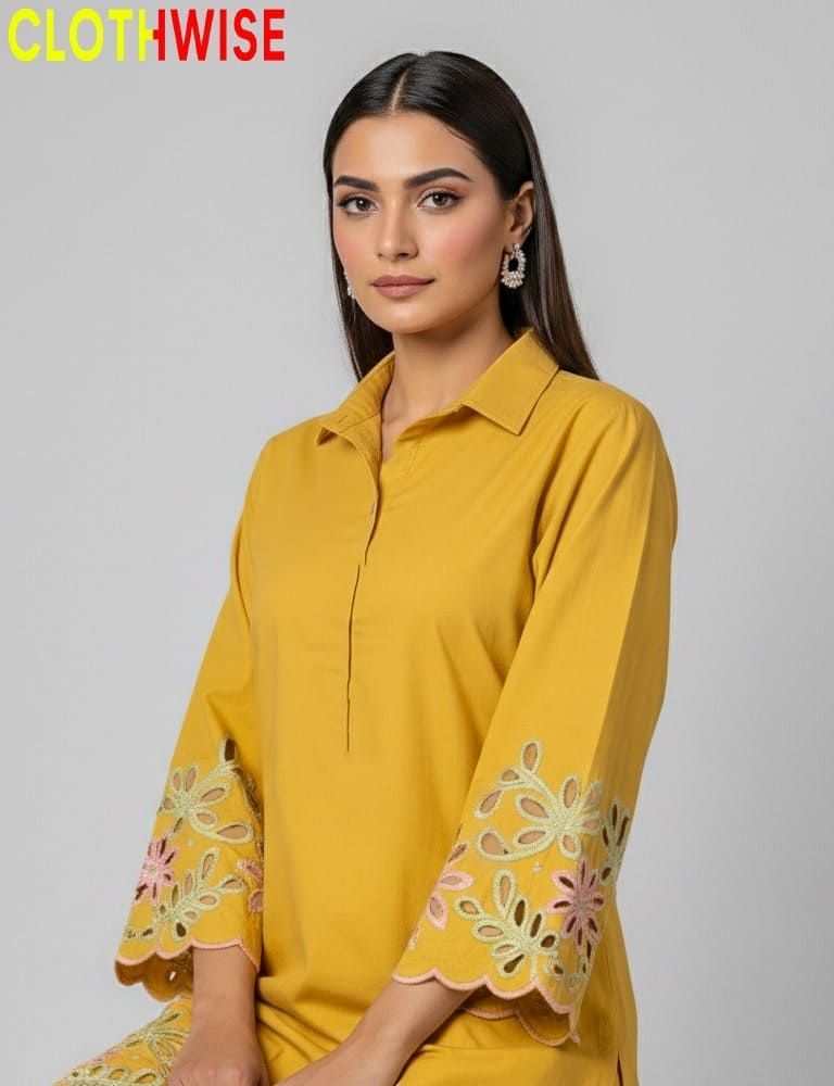Woman wearing a yellow dress with floral embroidery, branded 'CLOTHWISE'.