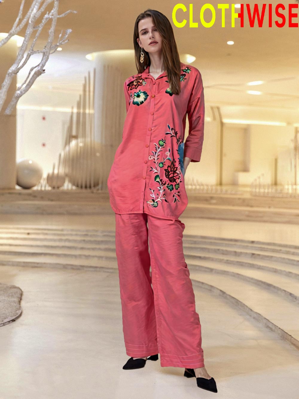 Woman wearing a pink outfit with floral embroidery in an indoor setting, branded 'ClothWise'.