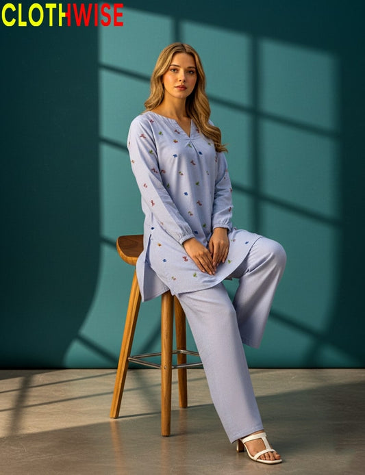 Woman sitting on a stool wearing a light purple outfit with a 'CLOTHWISE' logo.