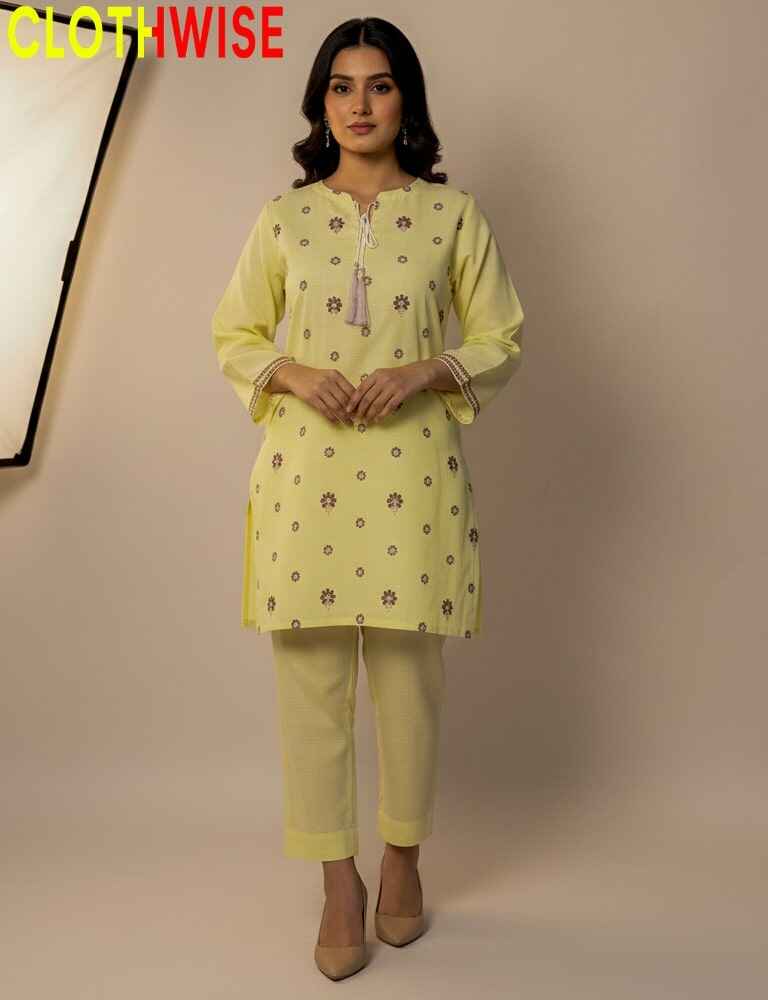 Woman wearing a light yellow kurta with pants on a beige background, with 'CLOTHWISE' branding.