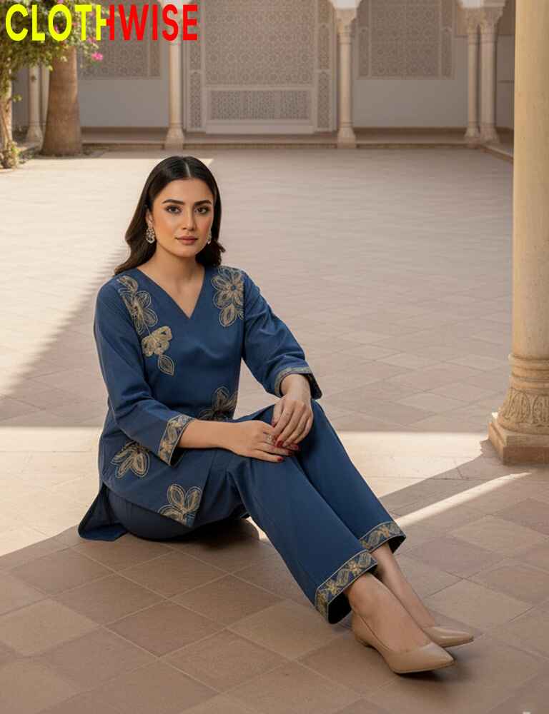 Woman in a blue traditional outfit sitting on a tiled floor with 'CLOTHWISE' branding.