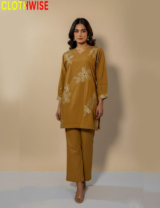 Woman wearing a mustard yellow outfit with floral embroidery on a beige background, branded 'ClothWise'.