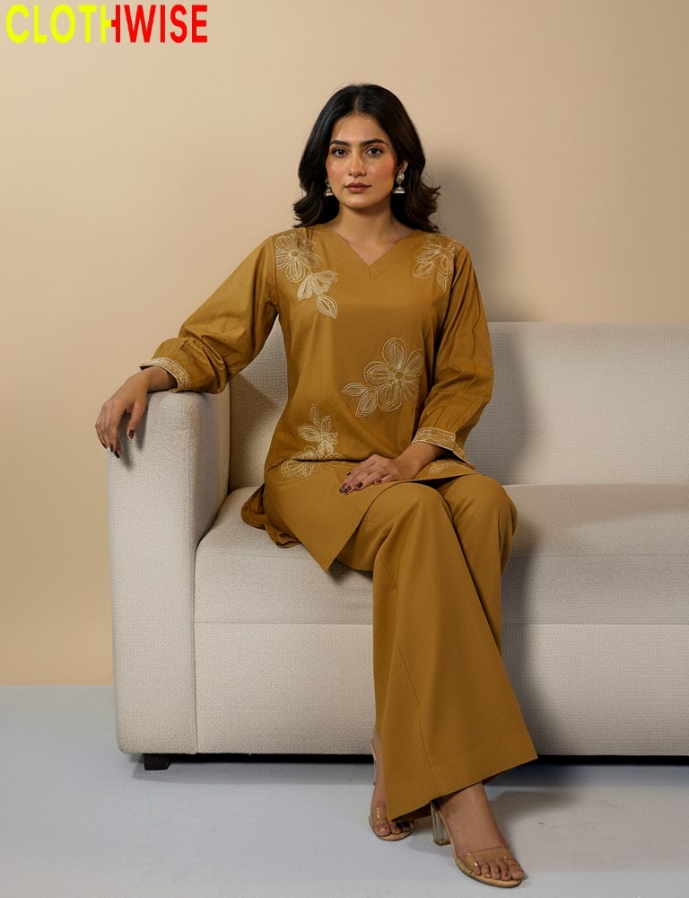 Woman in a mustard yellow outfit sitting on a white couch with 'ClothWise' branding.