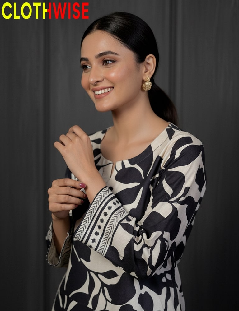 Woman wearing a black and white patterned dress with 'CLOTHWISE' branding.