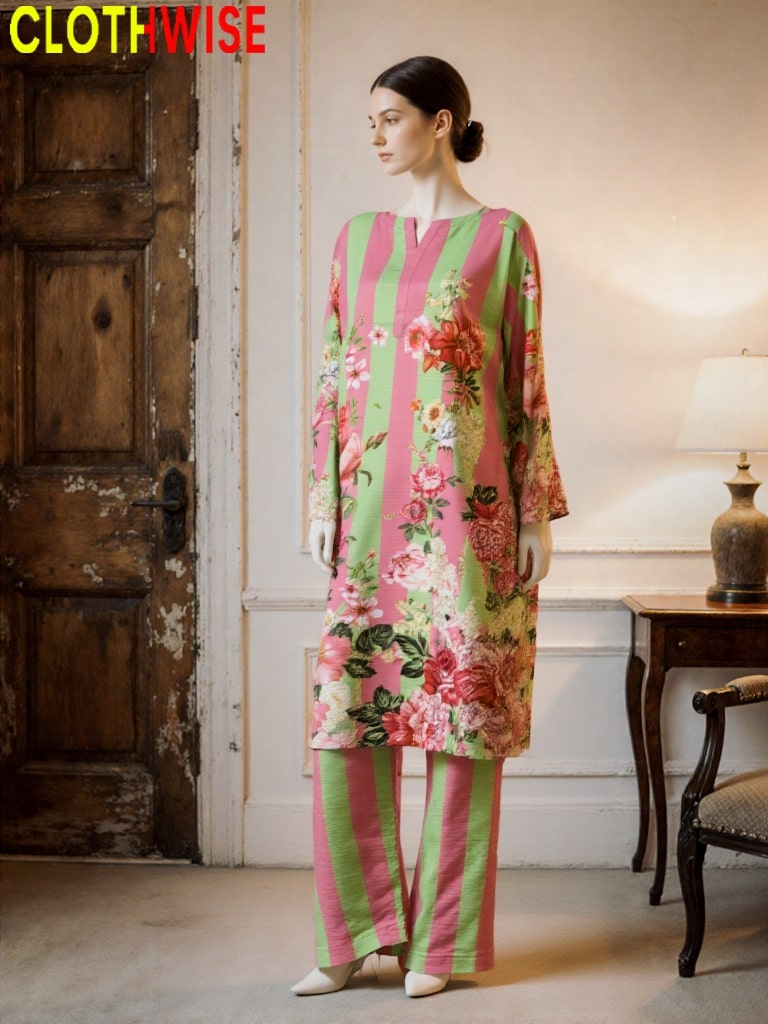 Woman wearing a colorful floral outfit in a room with a wooden door and lamp.