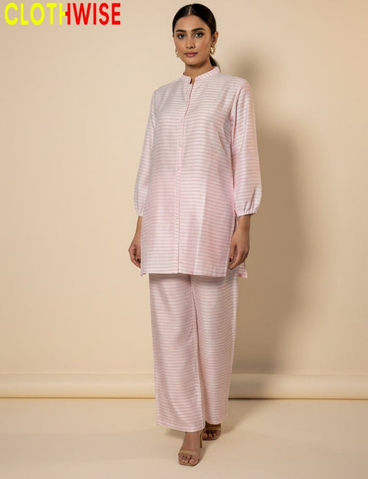 Woman wearing a pink and white striped outfit with 'CLOTHWISE' branding on a beige background