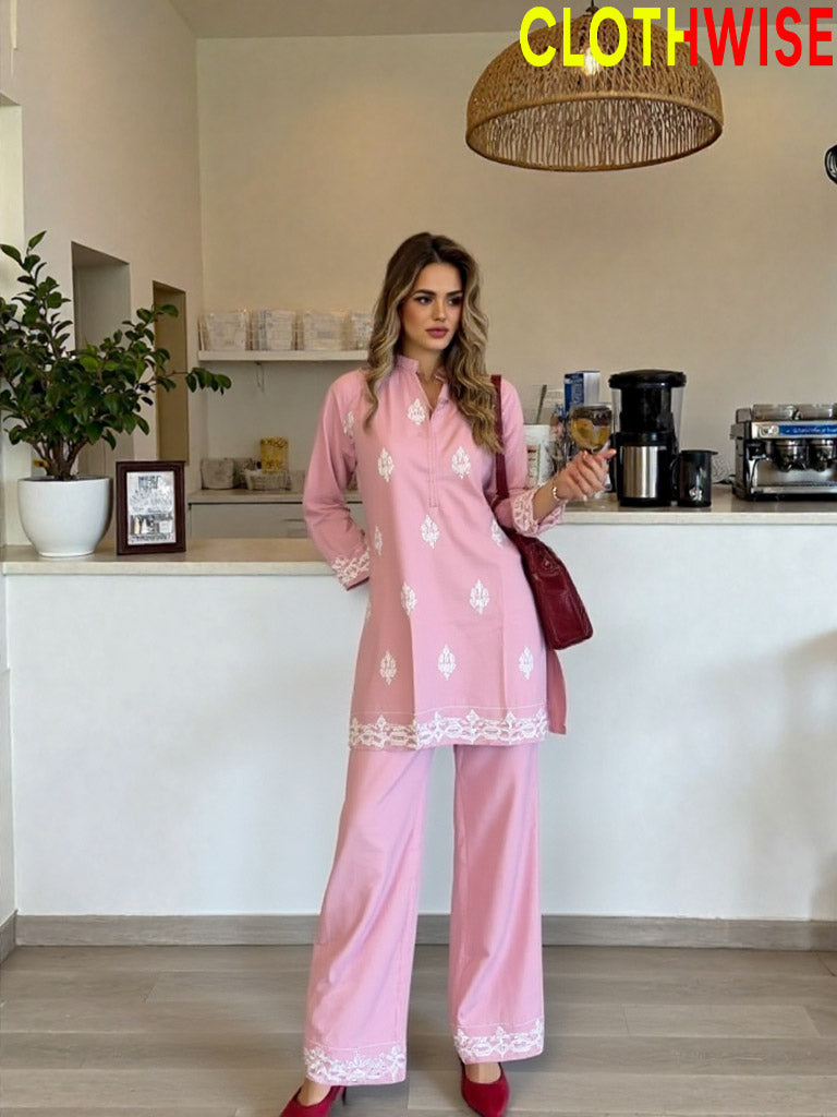 Woman in a pink outfit standing in a kitchen with 'ClothWise' branding.