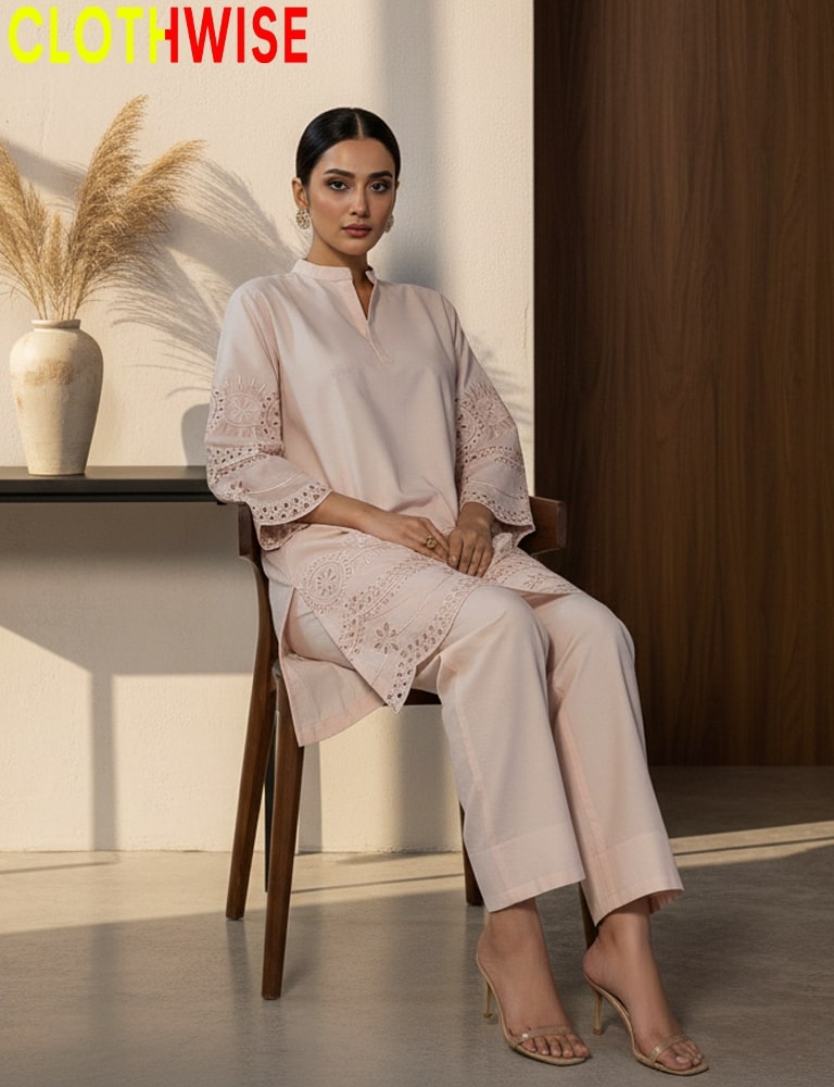 Woman sitting on a chair wearing a light pink outfit with lace details, with 'CLOTHWISE' branding.