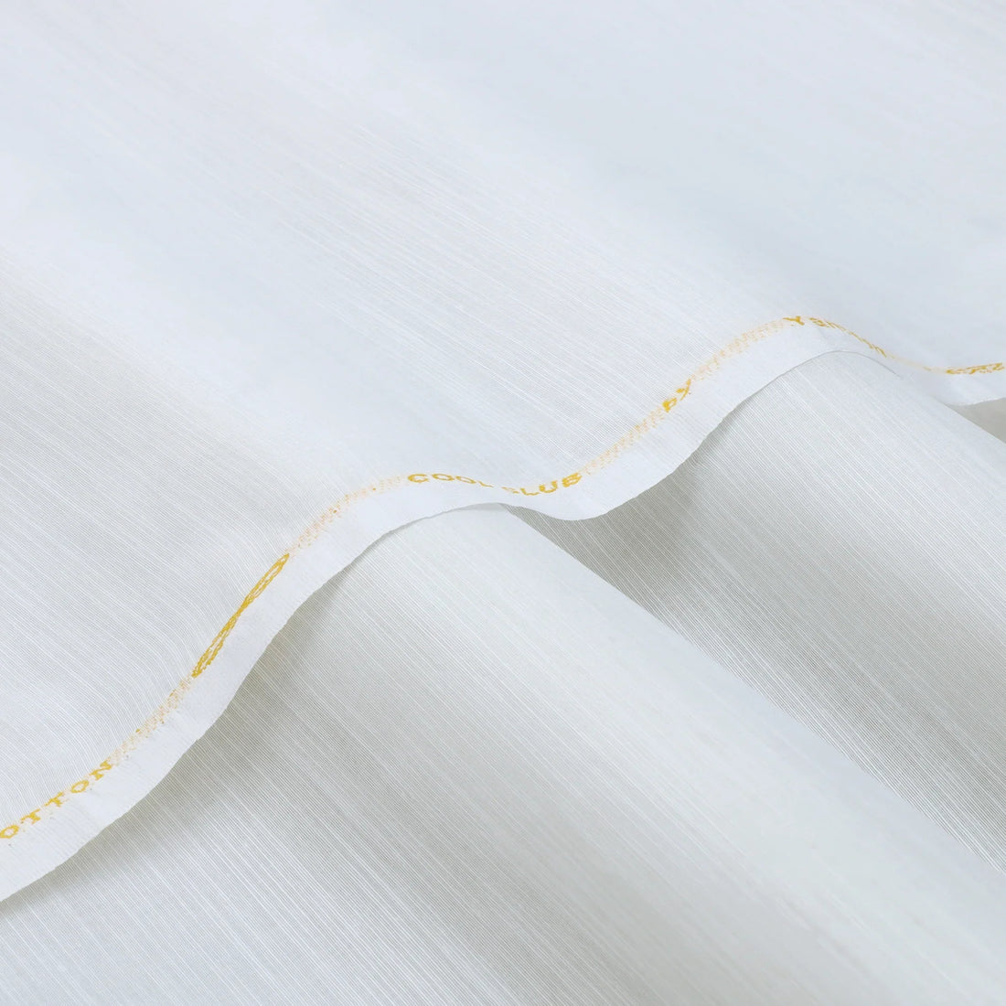 High-resolution close-up of slub lawn cotton fabric showing its characteristic uneven texture and breathability for all season wear.