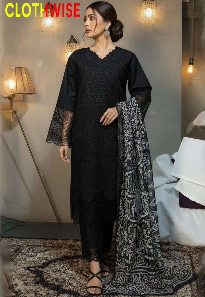 Woman in a black outfit with a patterned scarf, standing indoors with decorative lighting.