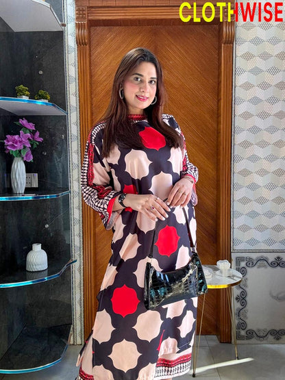 Woman in a patterned dress standing indoors with decor elements in the background