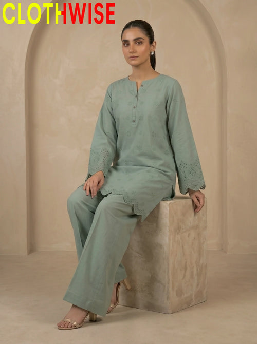 Tabeer Dusty Green suit sitting pose showing flapper bottom and chikankari embroidery | Clothwise