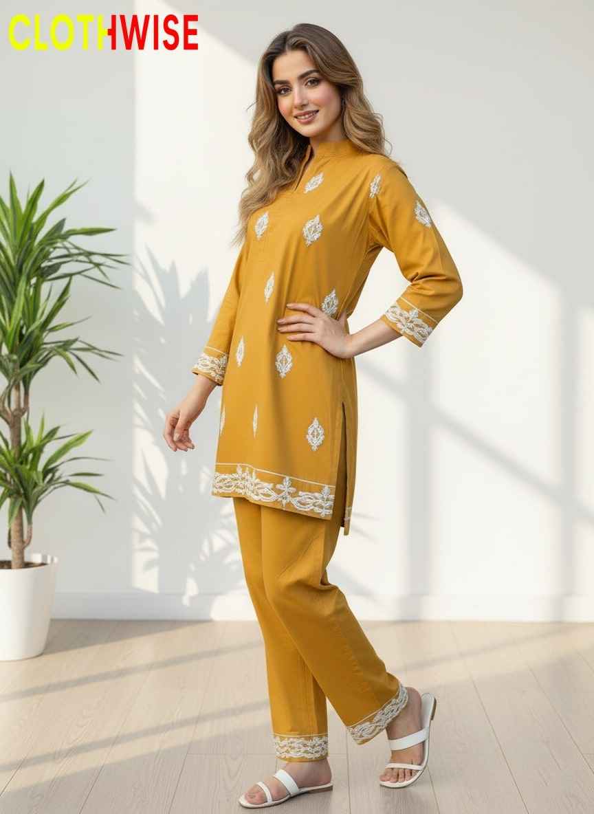 Woman wearing a mustard yellow outfit with white patterns indoors