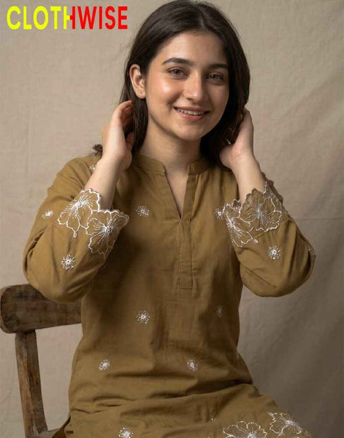 Woman wearing a brown embroidered outfit with 'Clothwise' branding.