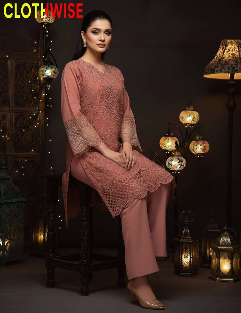Woman in a pink outfit sitting on a stool with decorative lights in the background, branded 'CLOTHWISE'.