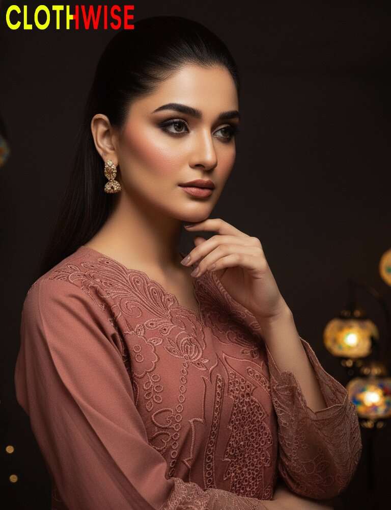 Woman wearing a pink embroidered outfit with 'CLOTHWISE' branding.