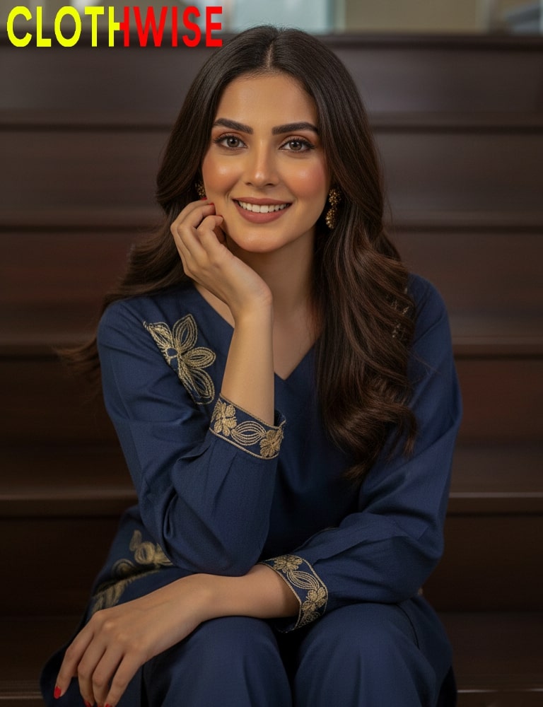 Woman wearing a blue outfit with gold embroidery sitting on steps, branded 'CLOTHWISE'.