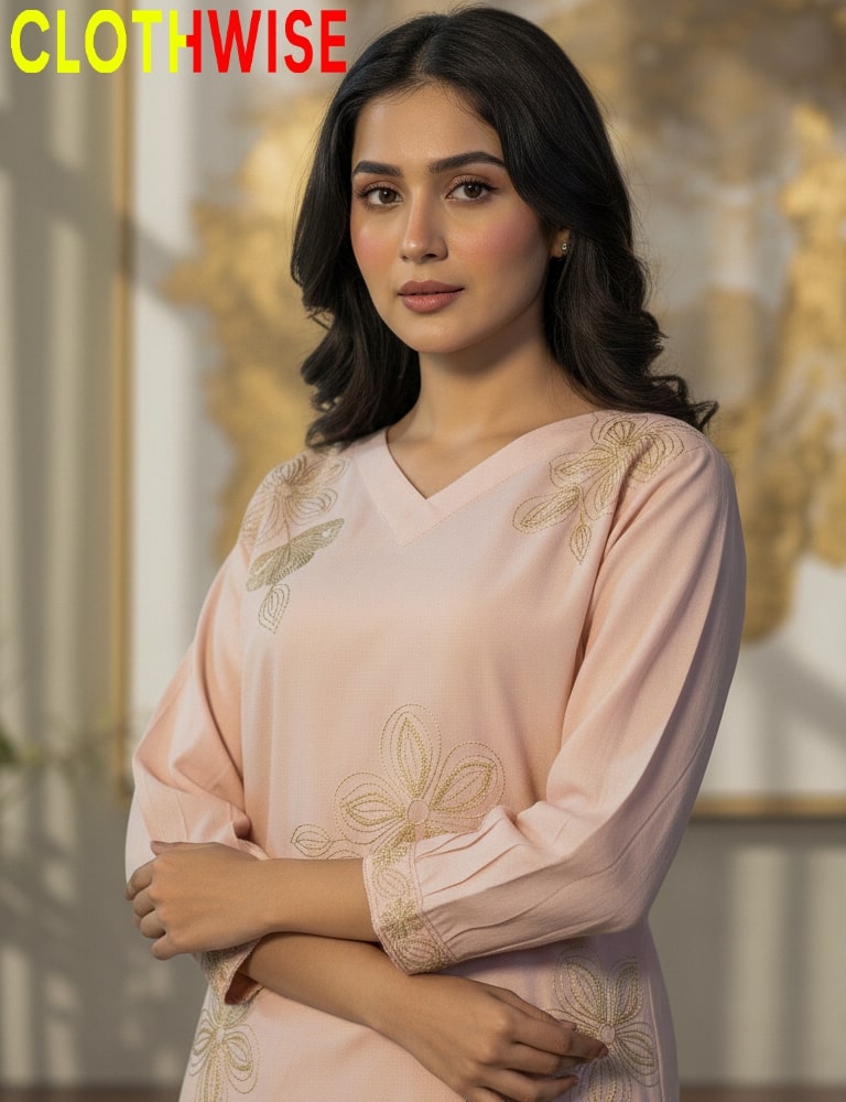 Woman wearing a light pink traditional outfit with floral embroidery, branded 'CLOTHWISE'.