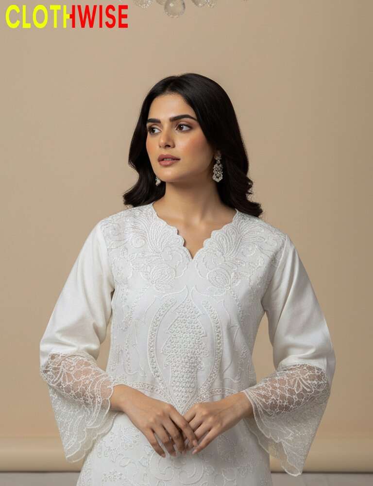 Woman wearing a white embroidered outfit with 'CLOTHWISE' branding.