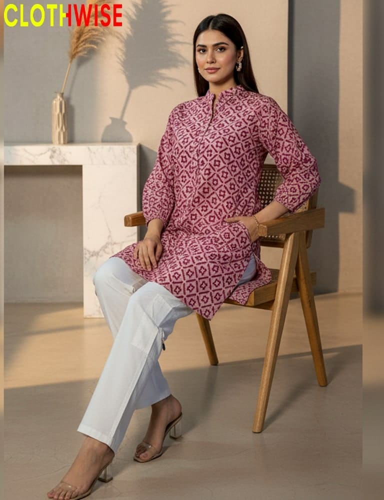 Woman sitting on a chair wearing a patterned pink kurta with white pants, with 'CLOTHWISE' branding.
