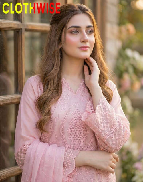 Woman wearing a pink lace dress with 'CLOTHWISE' branding.