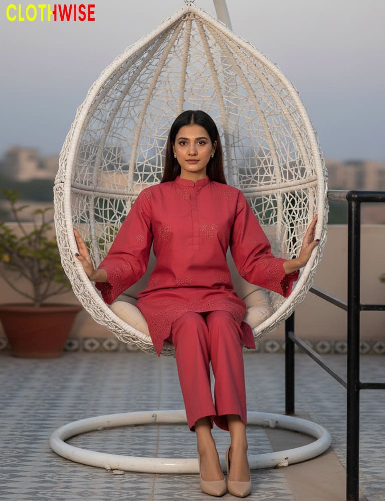Woman in a red outfit sitting in a white egg-shaped chair on a rooftop with 'CLOTHWISE' branding.