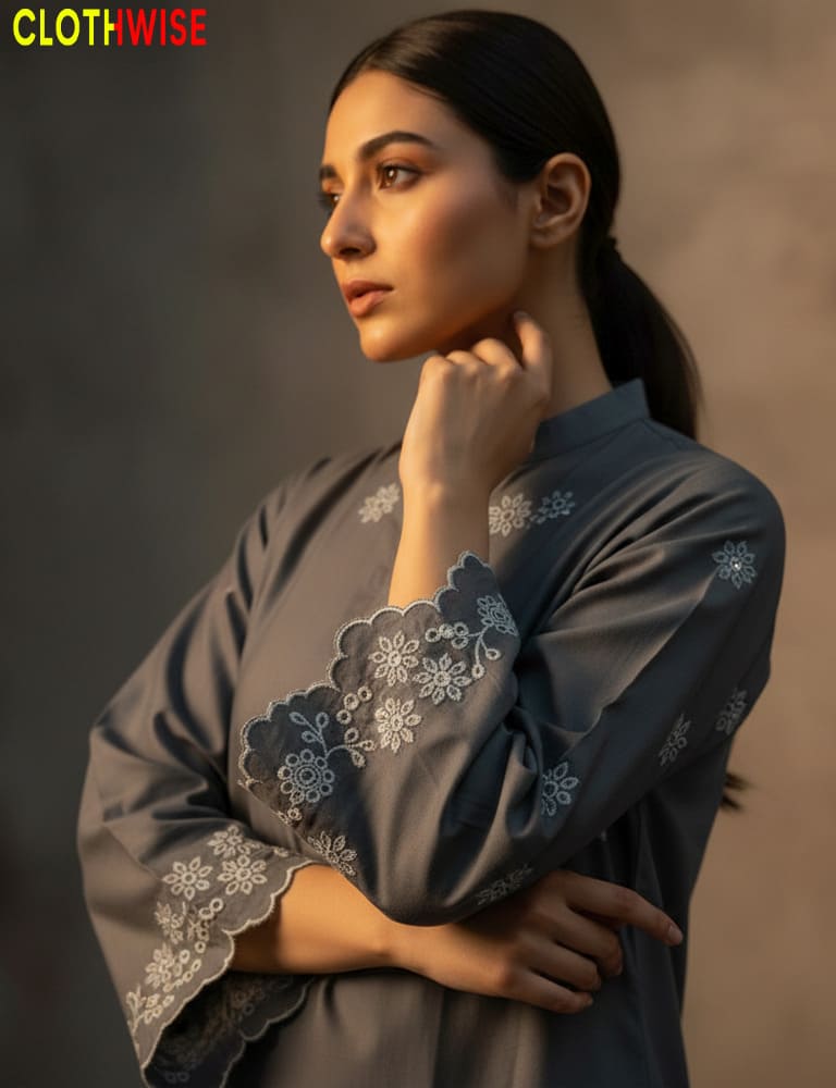 Woman wearing a gray embroidered outfit with a neutral background, featuring the brand 'Clothwise'.