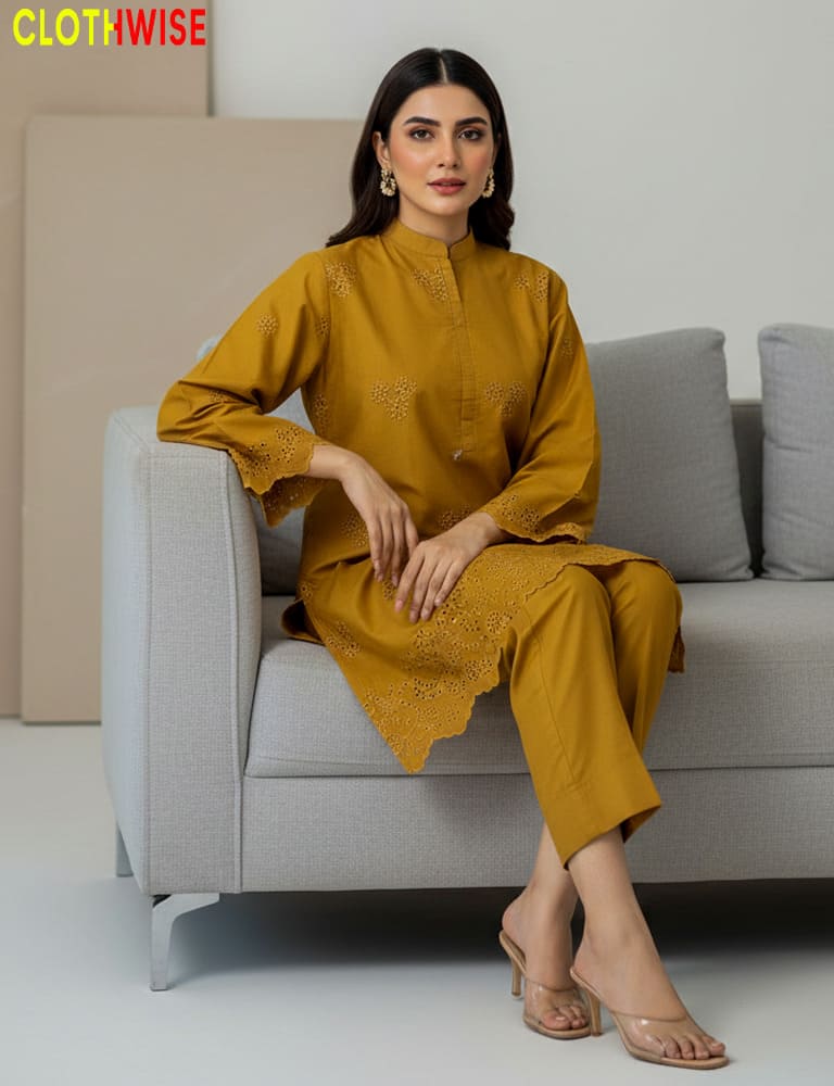Woman in mustard yellow outfit sitting on a gray sofa with 'Clothwise' branding.