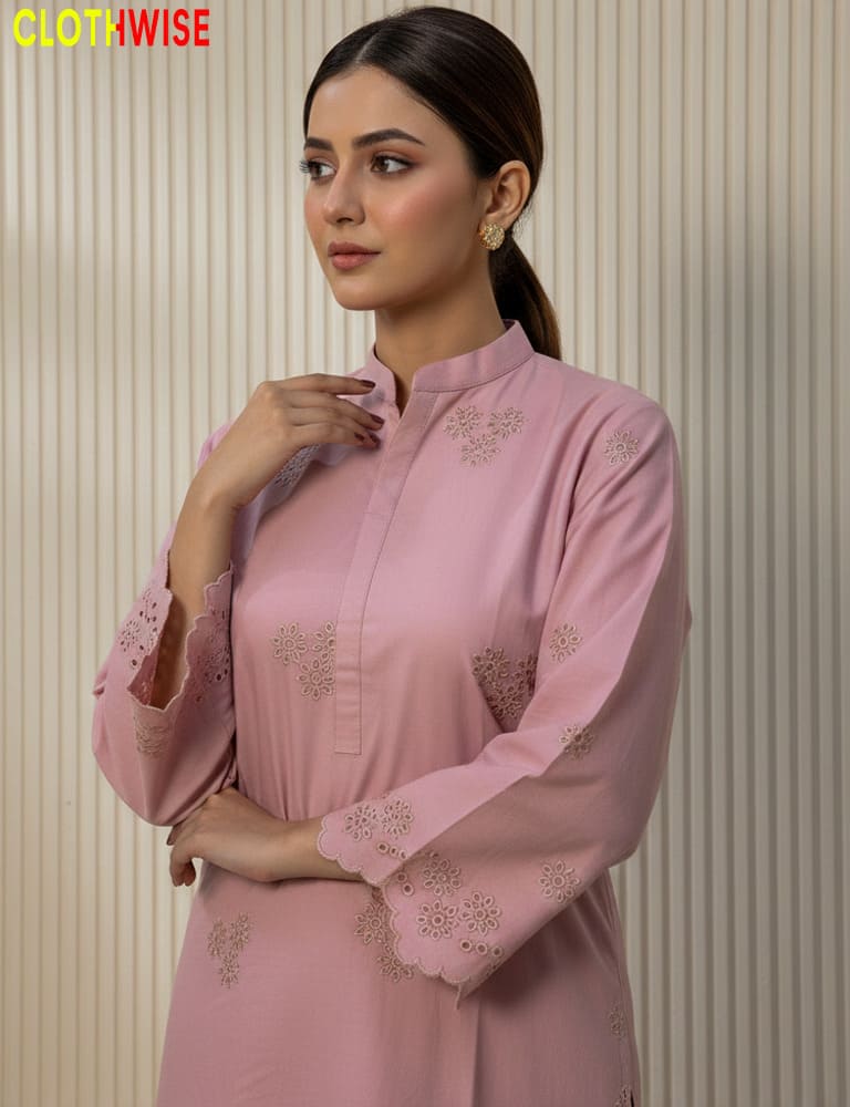 Woman wearing a pink embroidered outfit with 'CLOTHWISE' branding.