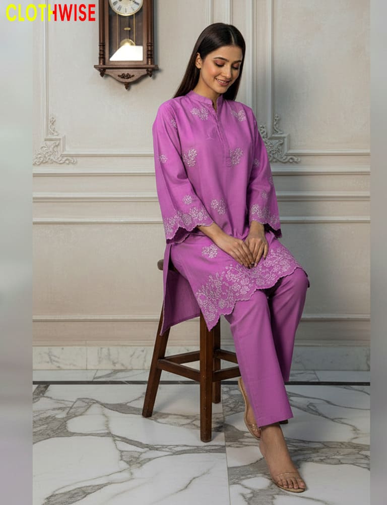 Woman in a purple outfit sitting on a wooden stool in a decorated room.