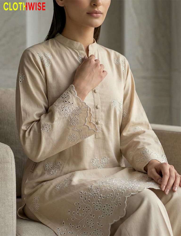 Person wearing a beige embroidered outfit with 'CLOTHWISE' branding.