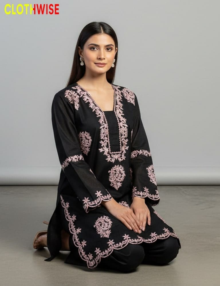 Woman wearing a black embroidered outfit with pink patterns on a gray background, branded 'ClothWise'.