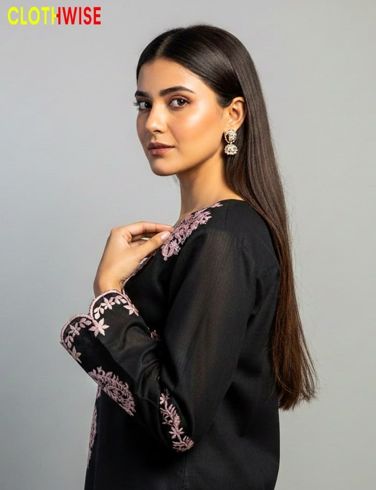 Woman wearing a black outfit with floral embroidery, 'ClothWise' brand visible.