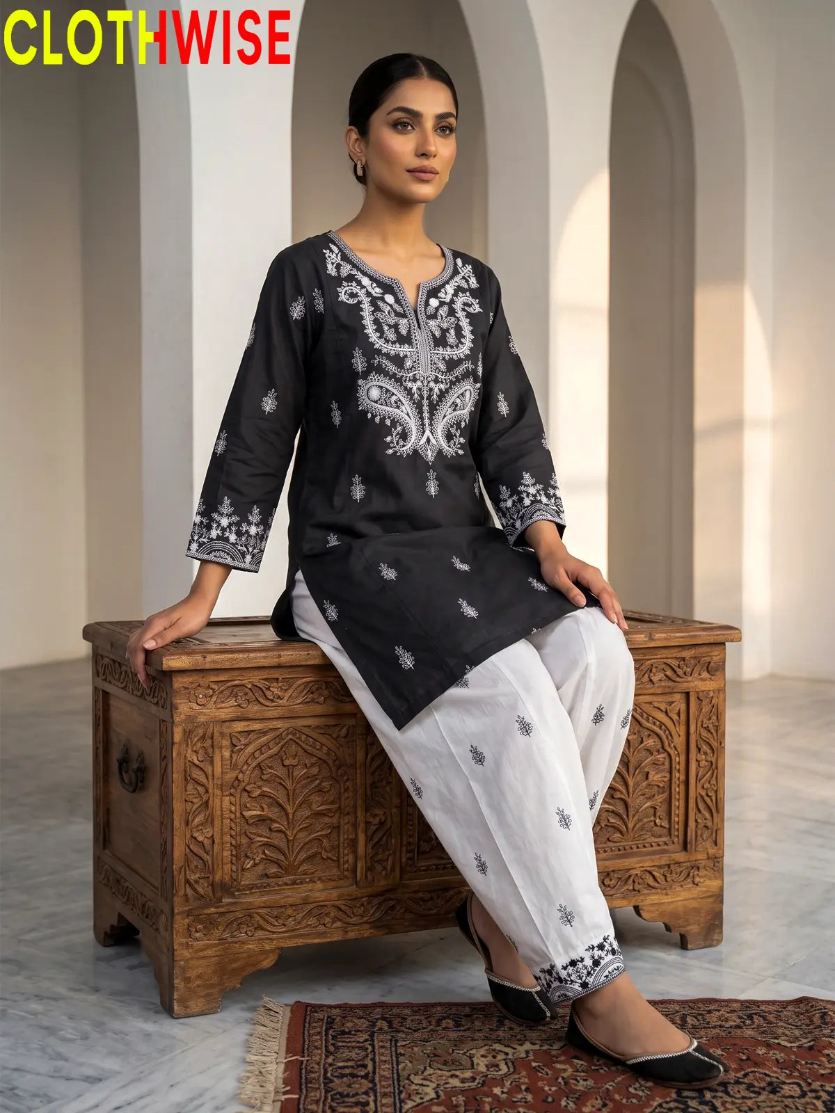 Mushq Black 2-piece cotton suit sitting pose