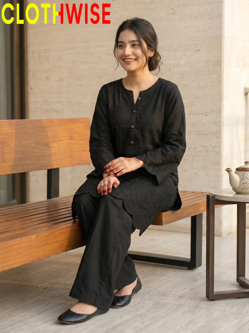 Midnight Chikankari Black suit sitting pose showing flapper bottom and chikankari embroidery | Clothwise