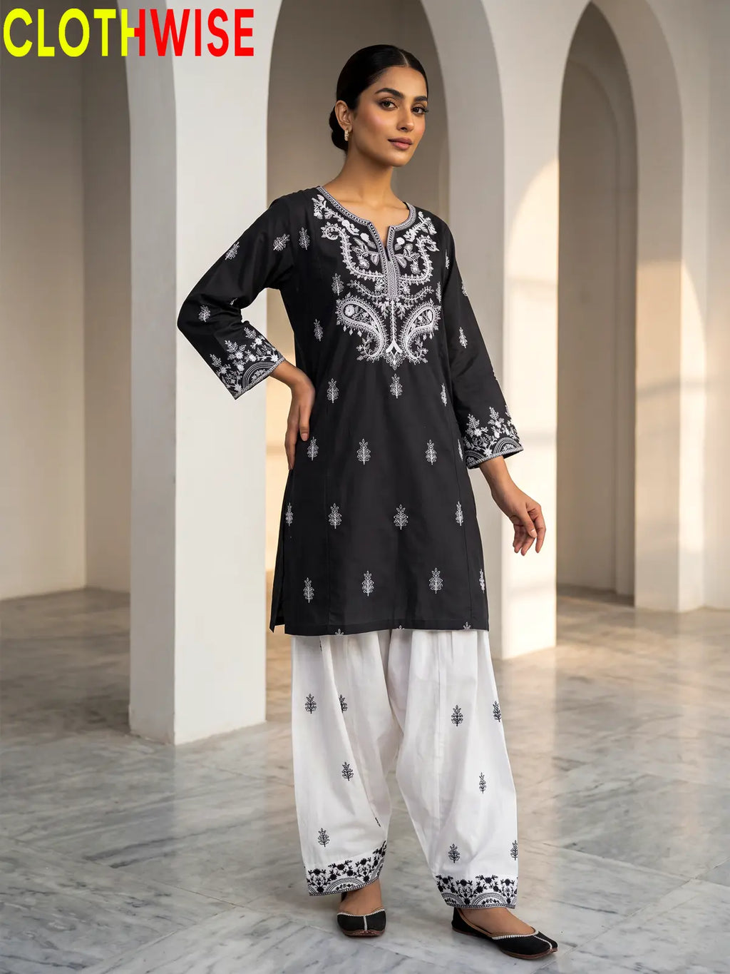 Mushq Black 2-piece cotton suit standing pose