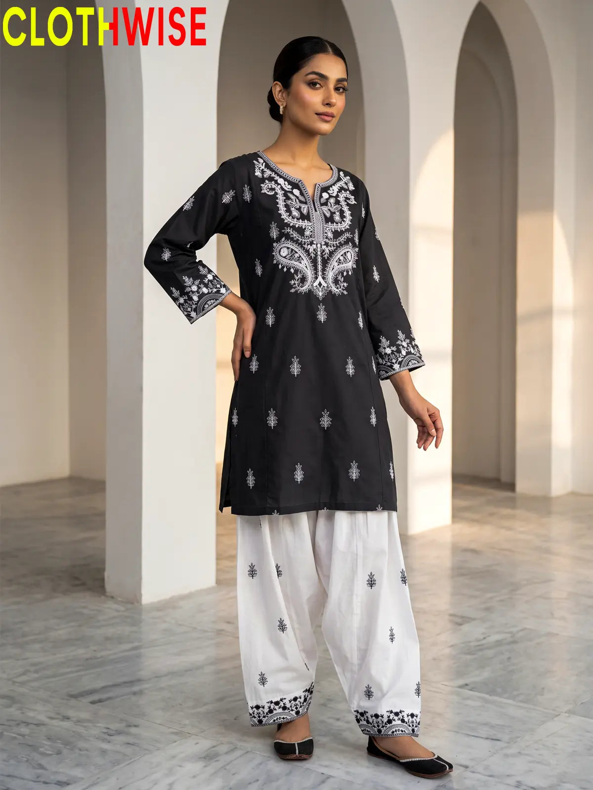 Mushq Black 2-piece cotton suit standing pose