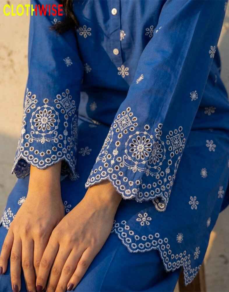 Blue embroidered garment with intricate patterns on a blurred background